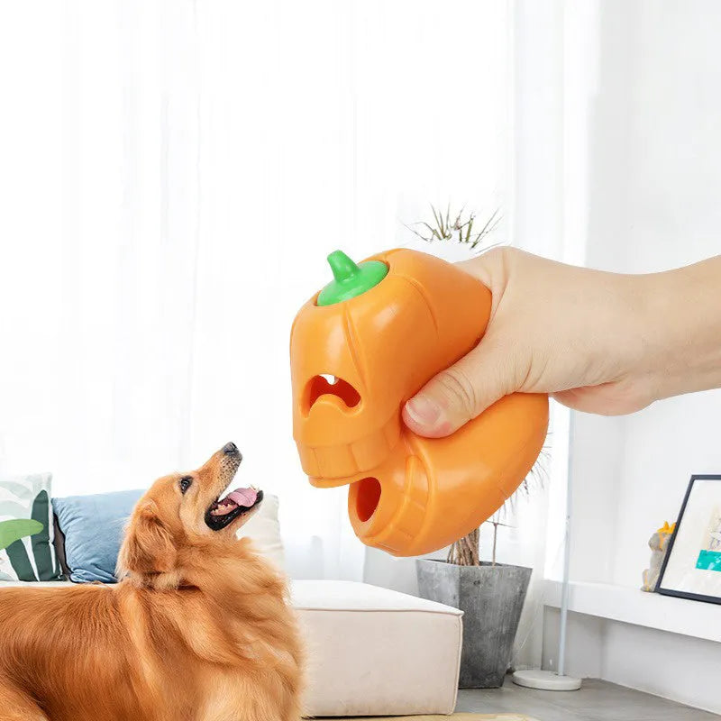 Orange Halloween pumpkin shaped dog chew toy with a treat-dispensing funnel hole.
