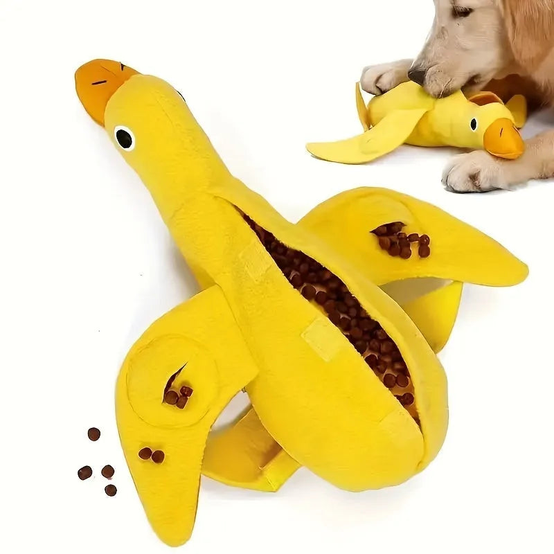 Yellow plush dog toy with attached rubber duck and a treat slot on a white background.