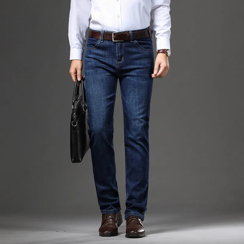 Man wearing straight-leg black stretch denim jeans with a mid waist and zip fly.