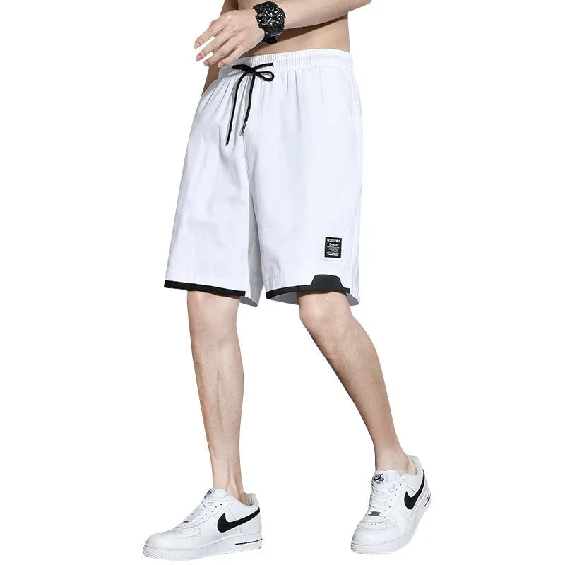 Boys' black cotton shorts in a plus size on a hanger