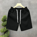 White jacquard shorts for men with straight cut and micro elastic fabric, displayed on a model