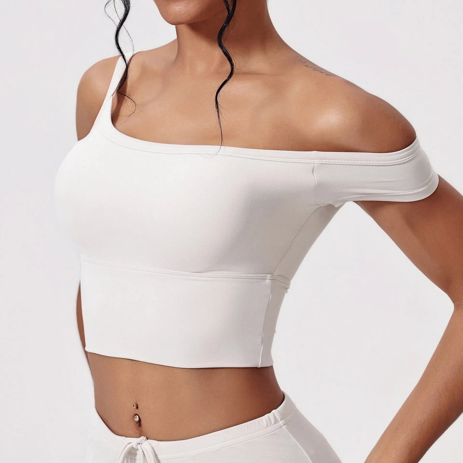Asymmetric padded yoga vest in white with wireless full cup design and fixed double straps for women