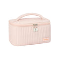 Open-top pink cake-style makeup bag made from PU leather on a table.