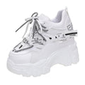 Women's white low-top platform tennis shoes with mesh upper and cross-strap detail on a rubber sole.