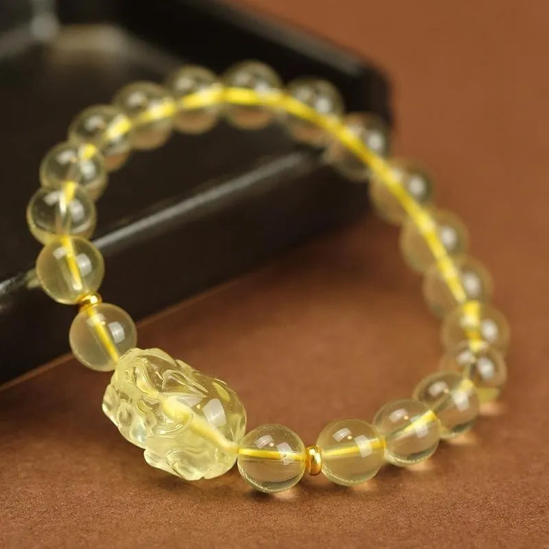 Yellow leather bracelet with a detailed golden citrine Pi Xiu crystal charm.