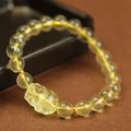 Yellow leather bracelet with a detailed golden citrine Pi Xiu crystal charm.