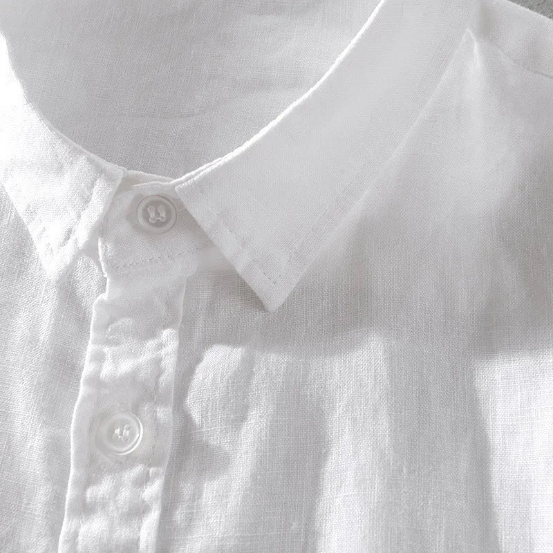 Man wearing a light apricot coloured loose fit short sleeve linen shirt for casual leisurewear.