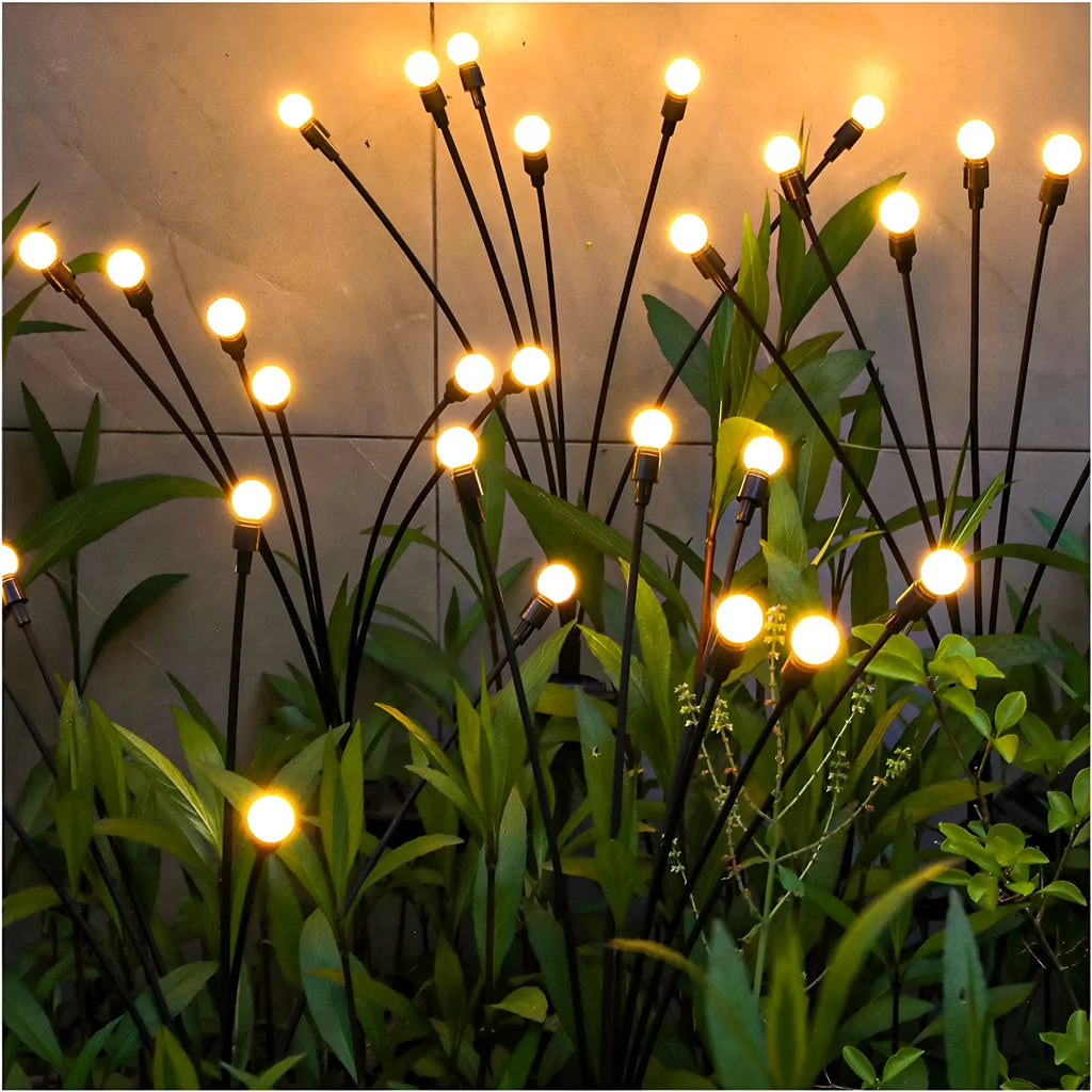 Solar-powered LED firefly ground lights with stainless steel stake for garden installation
