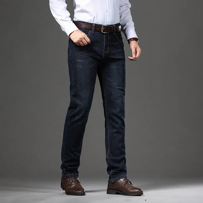 Man wearing straight-leg black stretch denim jeans with a mid waist and zip fly.