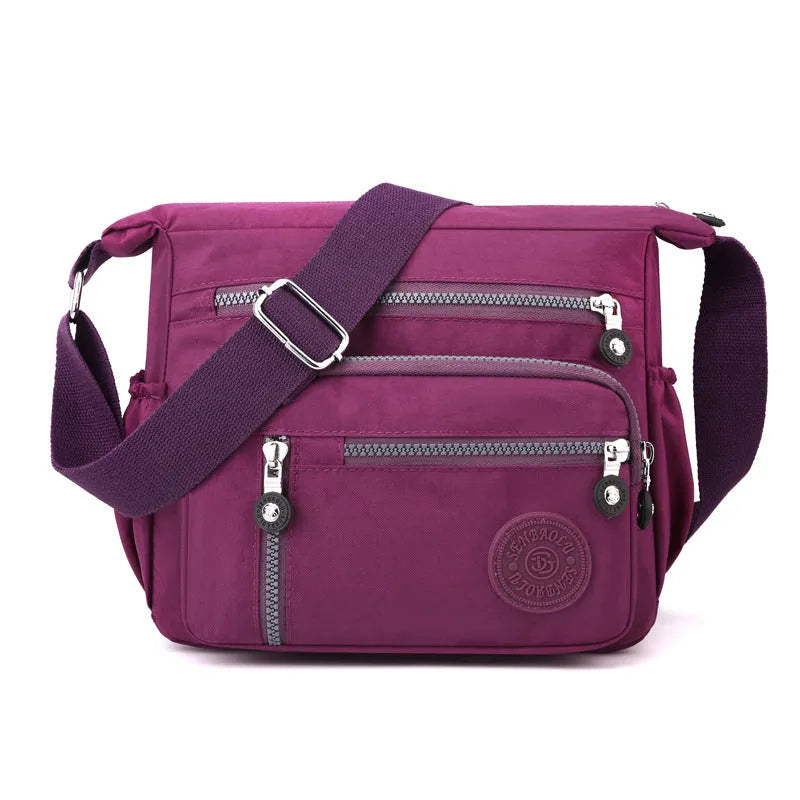 Grey nylon shoulder messenger bag with single strap and square vertical design