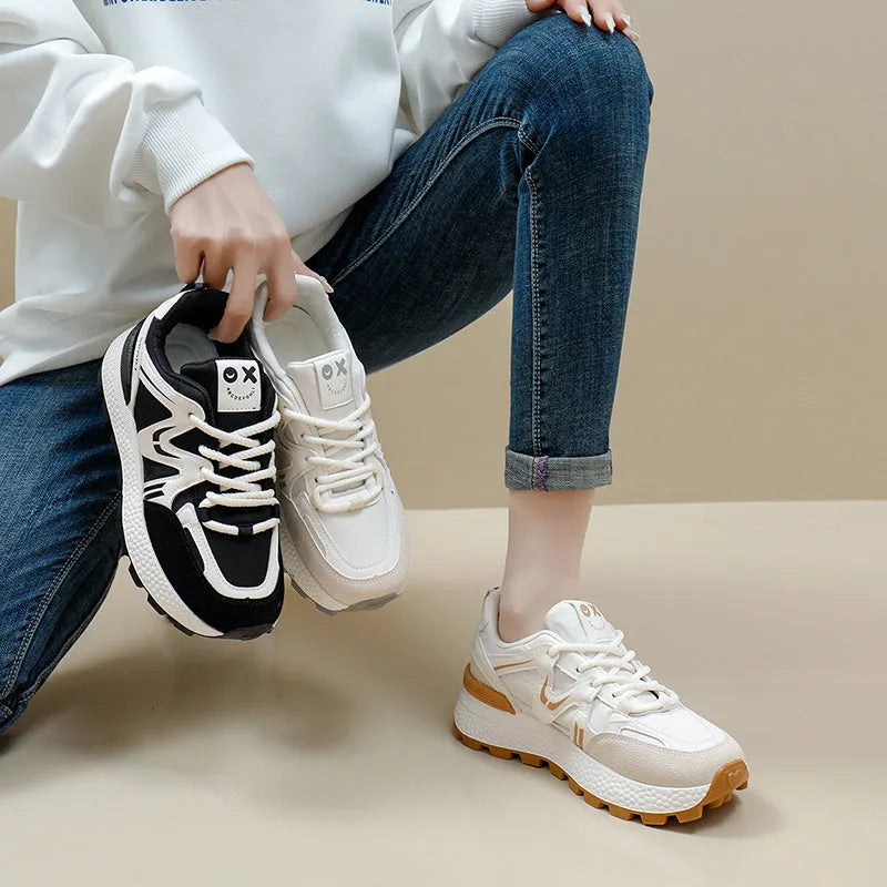 Women's black platform casual shoes with round toe and front lace-up design on a neutral background.