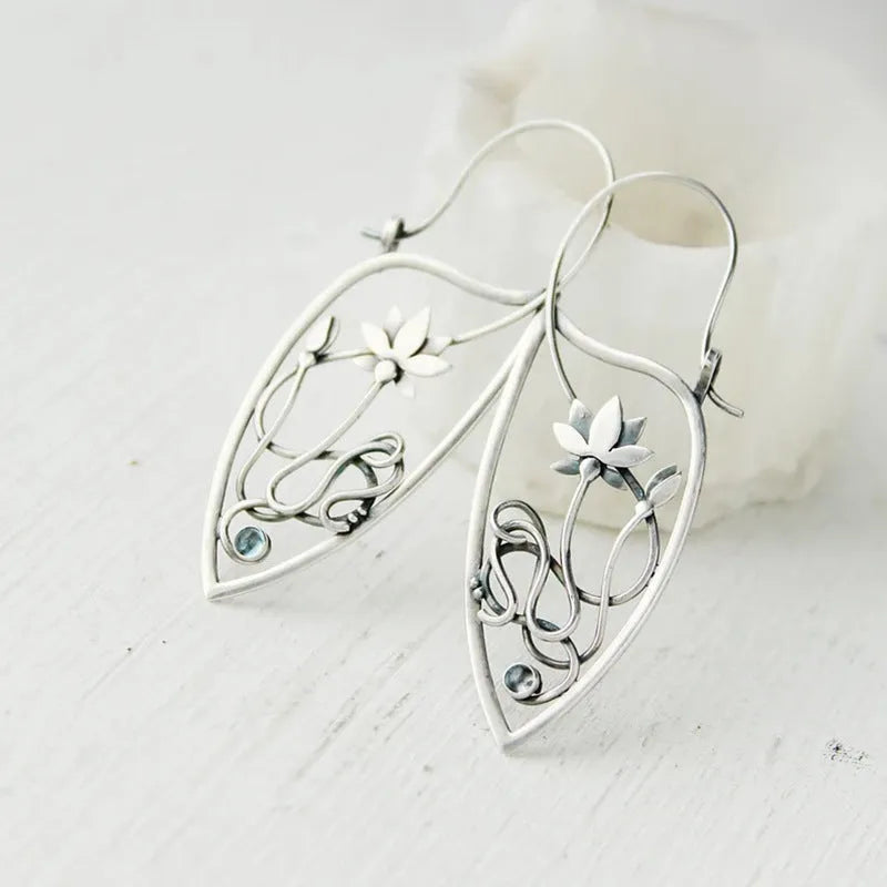 Silver rhinestone earrings with lotus vine design featuring geometric floral shapes and round crystal elements