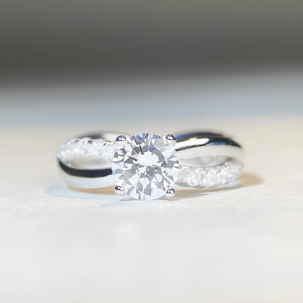 White Diamond 1 karat moissanite ring with twisted Sterling Silver band and four-claw setting.