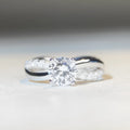 White Diamond 1 karat moissanite ring with twisted Sterling Silver band and four-claw setting.