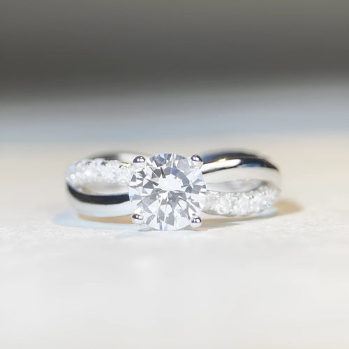 White Diamond 1 karat moissanite ring with twisted Sterling Silver band and four-claw setting.