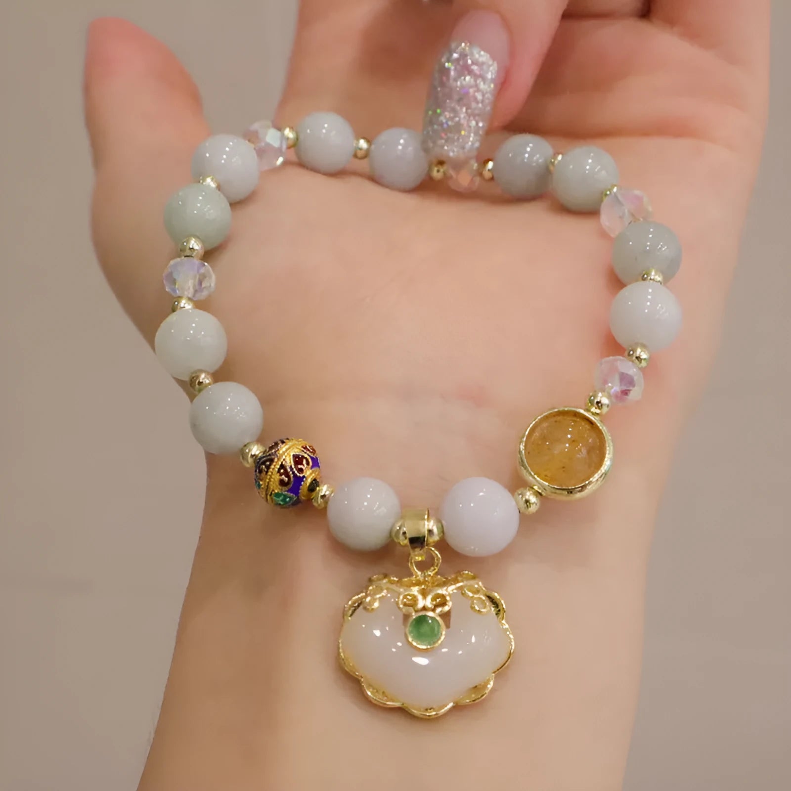 Geometric ethnic bracelet with natural jade, strawberry quartz stones and metal decorations