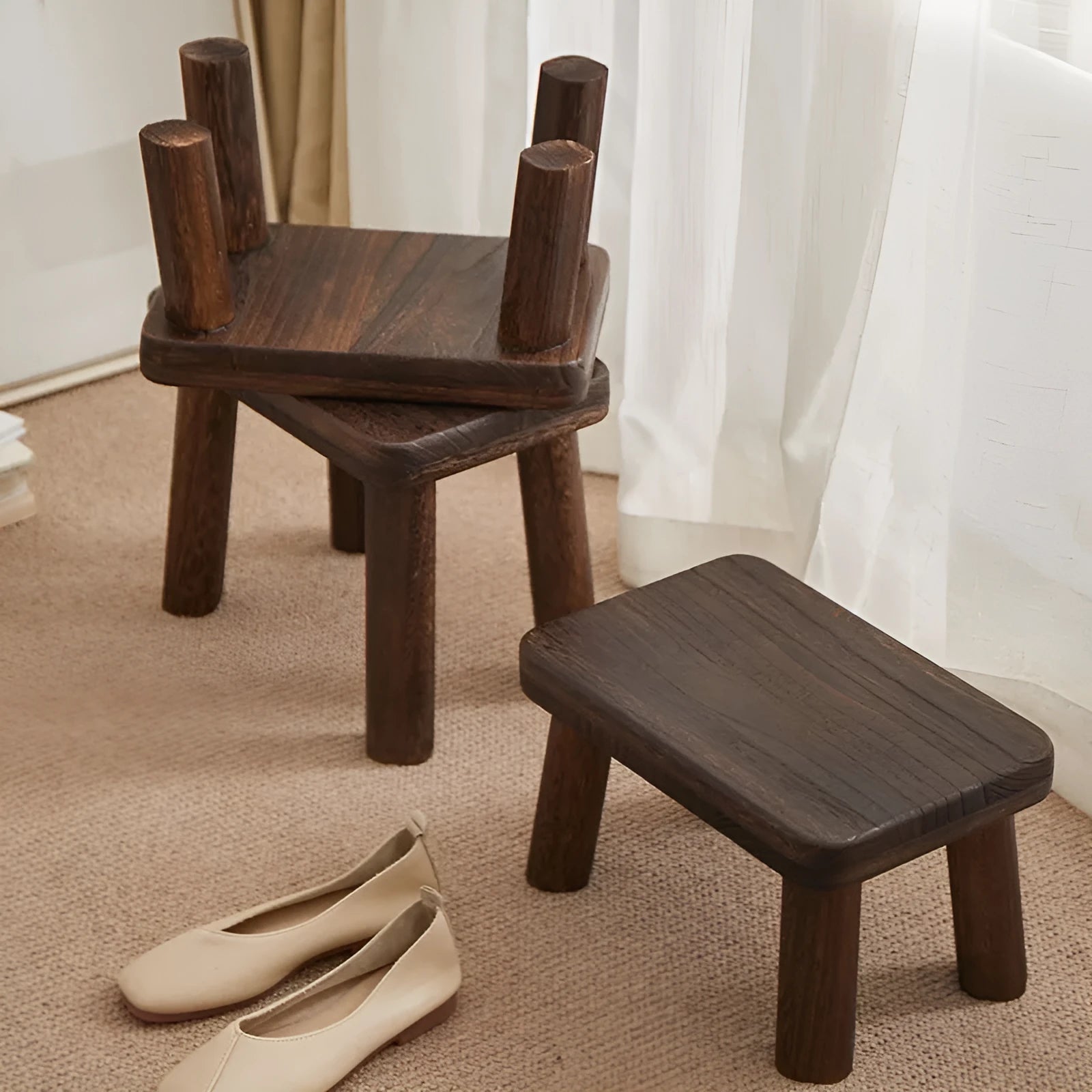 Solid wooden shoes changing stool with a distressed finish and bracket leg structure.