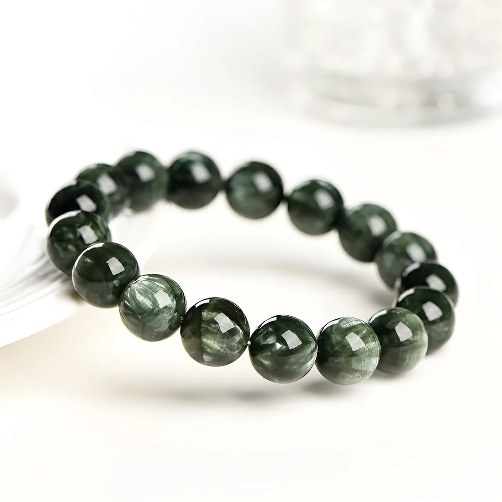 Green Dragon Crystal bracelet with round 8-9mm beads on a wrist.