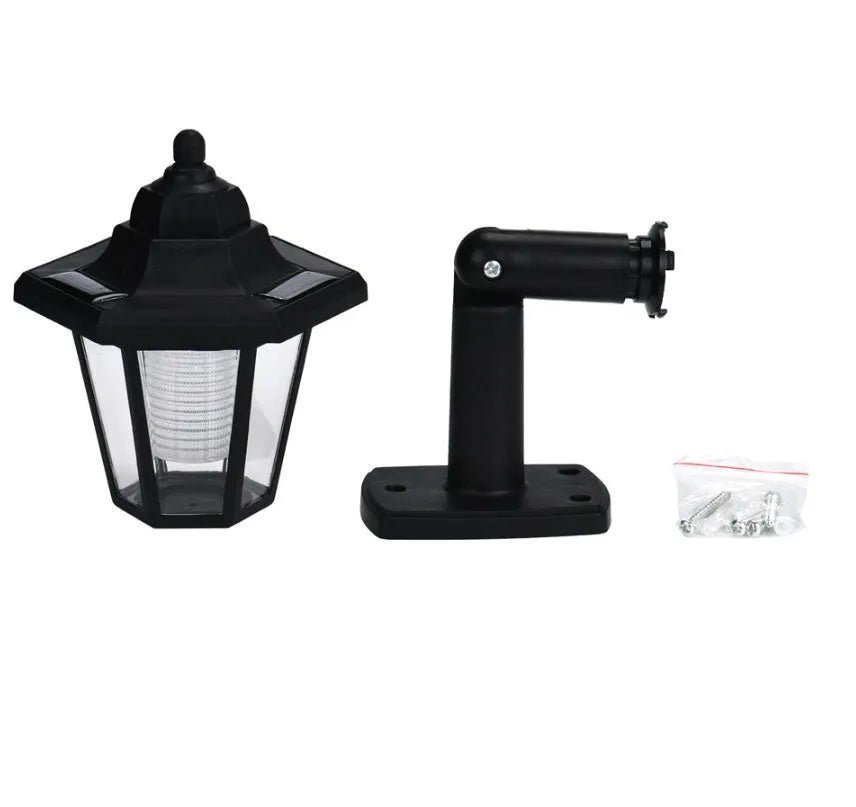 Black hexagonal solar wall lamp with solar panel, measuring 13x15x22cm