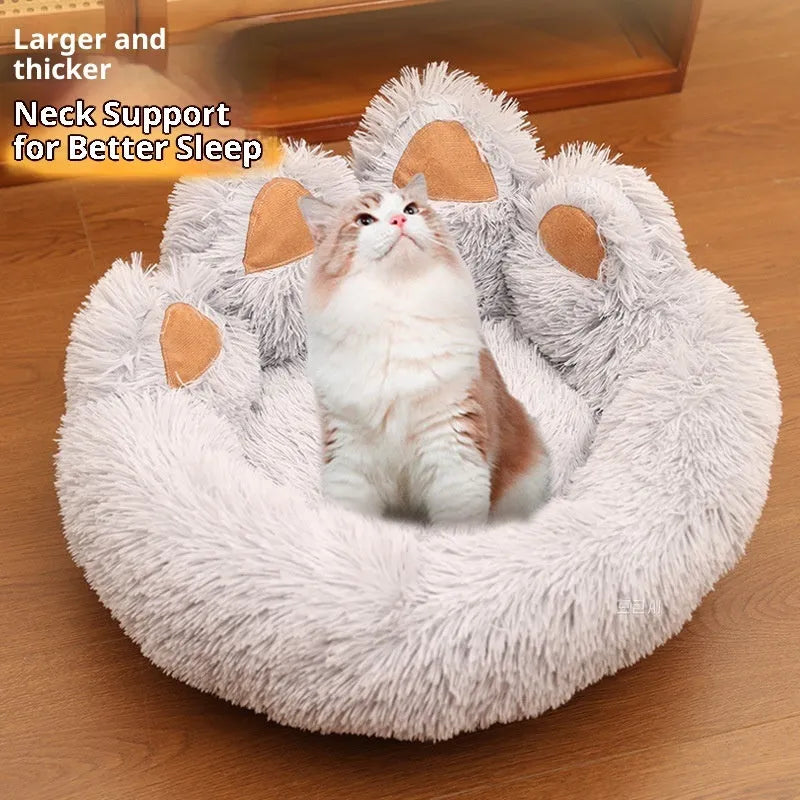 Round plush pet bed in coffee colour with raised rim and textured hand-shaped brush nest surface