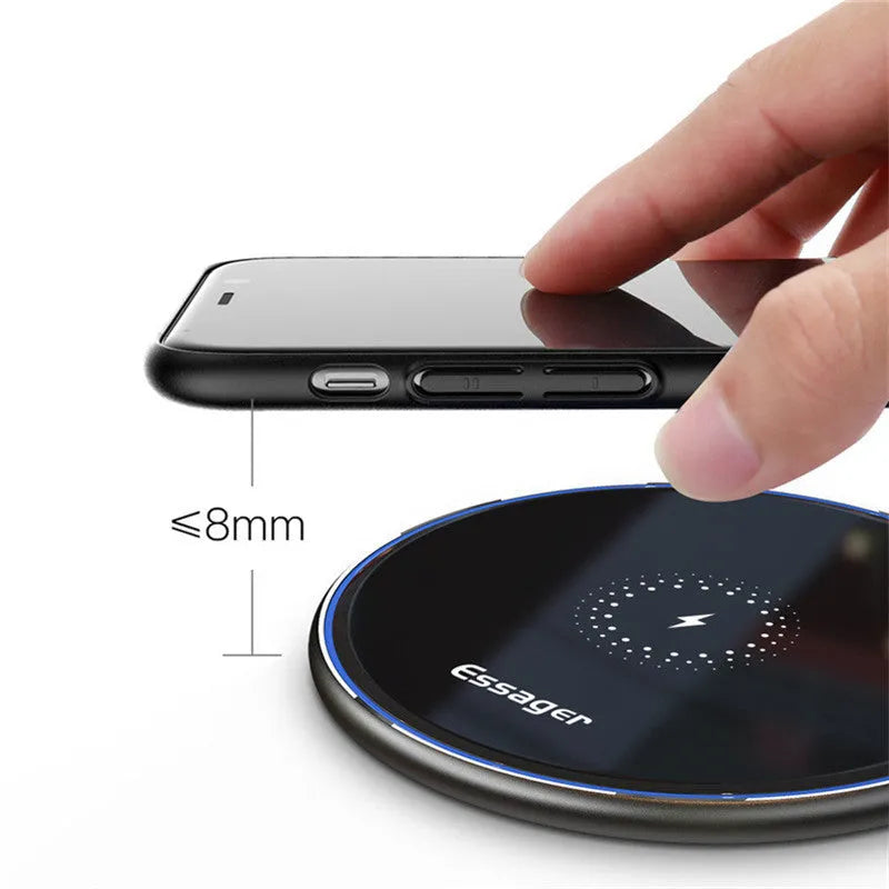Black aluminium wireless charging pad with LED indicator light on smooth surface