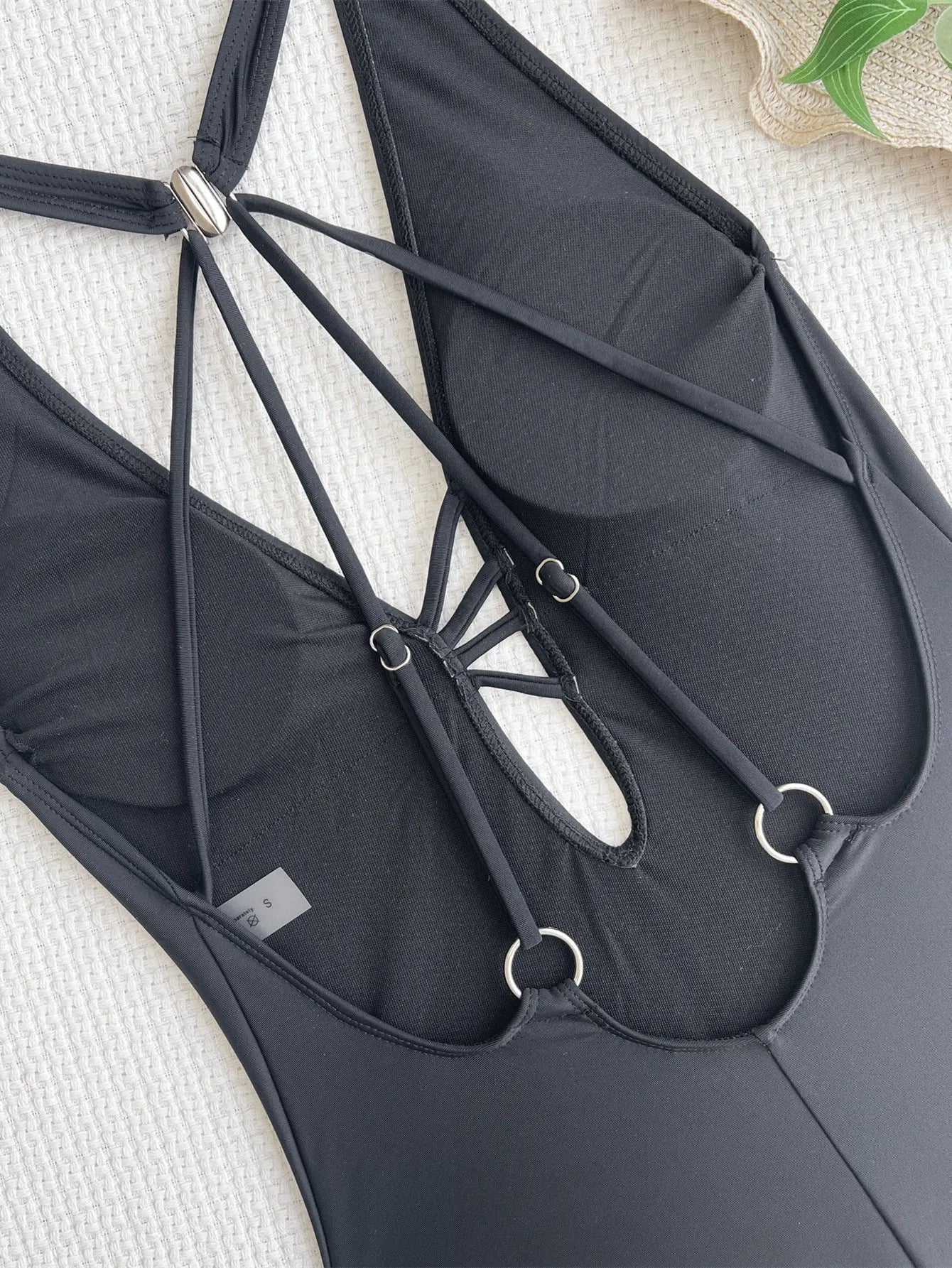 Black solid colour one-piece ladies bikini swimsuit made from nylon fabric.