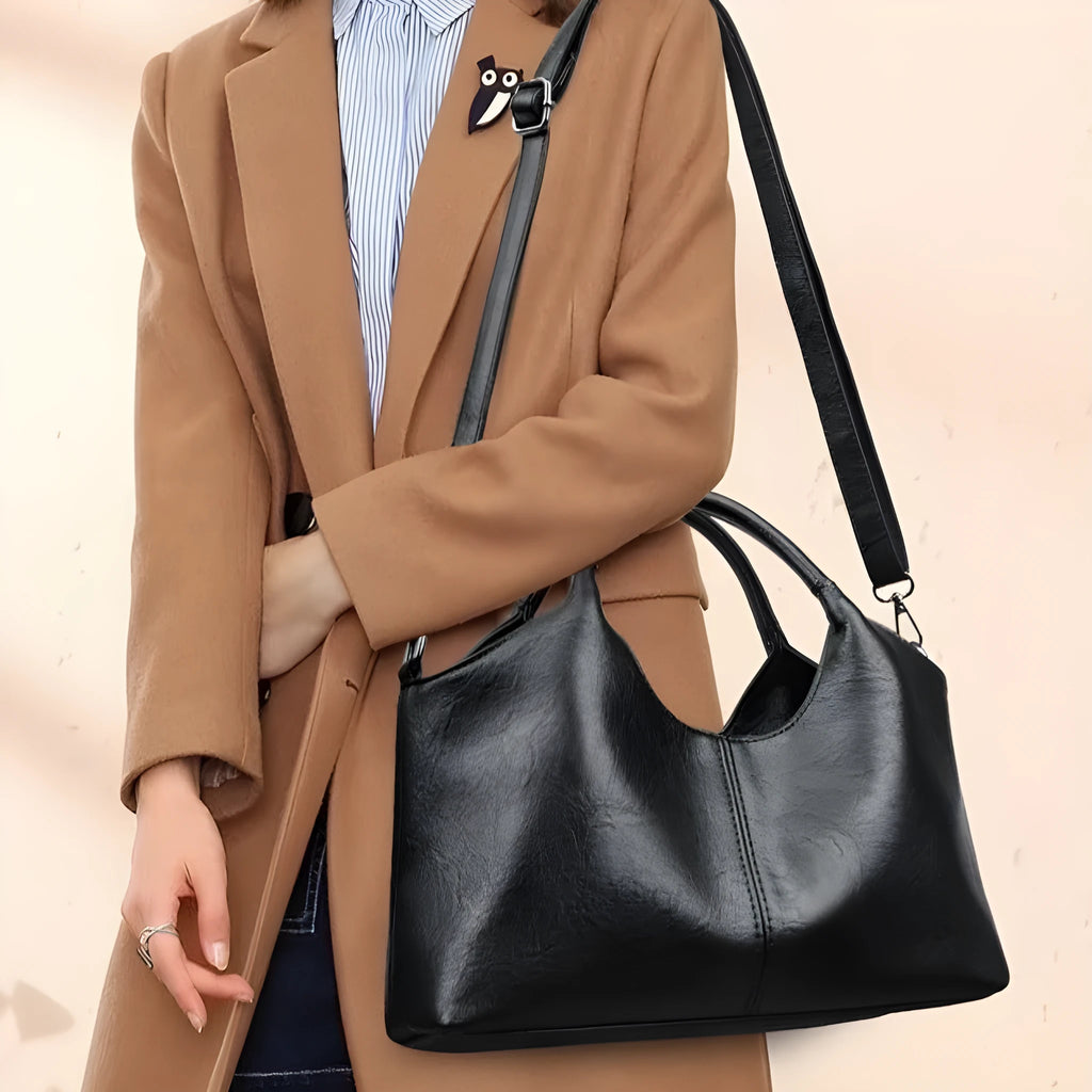 A genuine leather women's cross-body bag in a choice of seven colours including black, brown, and wine red.
