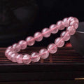 Women's strawberry quartz crystal bracelet with polished beads in 6mm, 8mm, and 10mm size options.