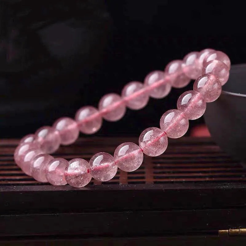 Women's strawberry quartz crystal bracelet with polished beads in 6mm, 8mm, and 10mm size options.