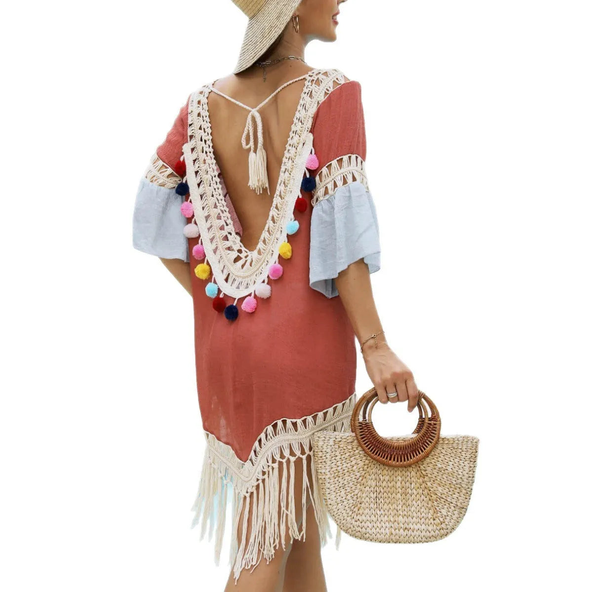 Orange floral beach overskirt with hand crochet detail and cotton tassels laid flat