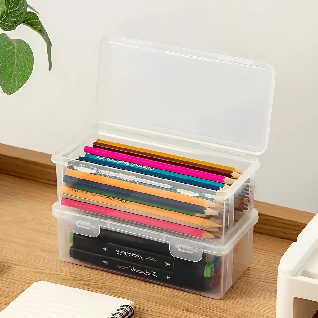 Transparent plastic stationery storage box containing pencils and drawing supplies