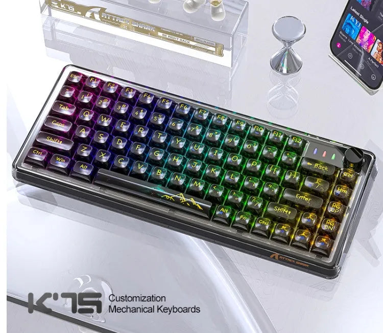 Attack Shark K75RGB wireless mechanical keyboard with transparent white case and RGB backlighting on a desk.