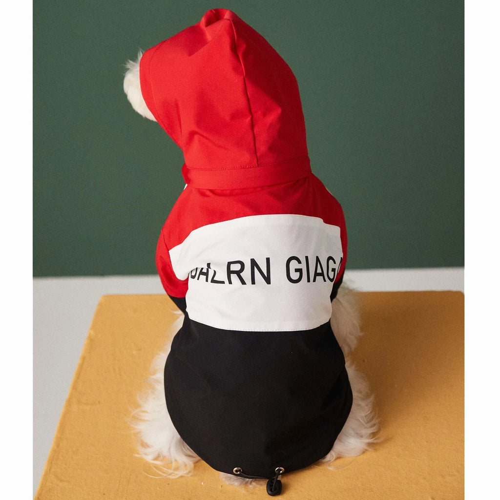 Red waterproof polyester dog raincoat jacket laid flat showing front view with hood