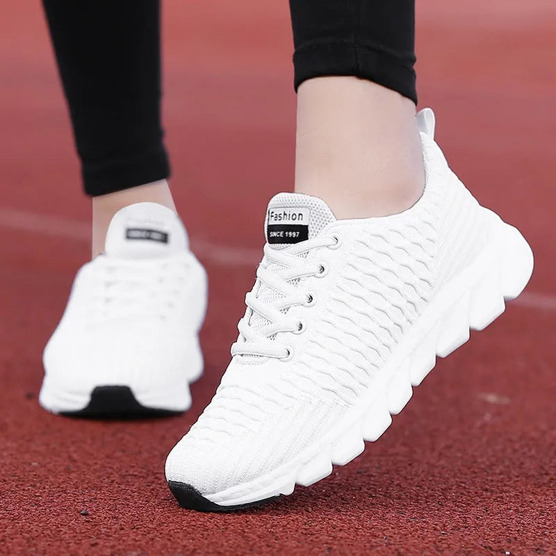 Women's running shoes with fly weave upper in black, pink, or white, showing wear-resistant outsole.