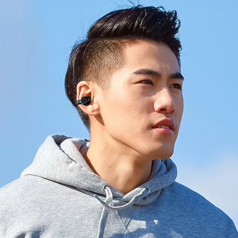 Black clip-on wireless bone conduction Bluetooth headset for sports and exercise.