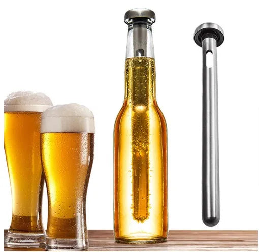 Silver stainless steel wine cooling rod with pourer next to a red wine bottle