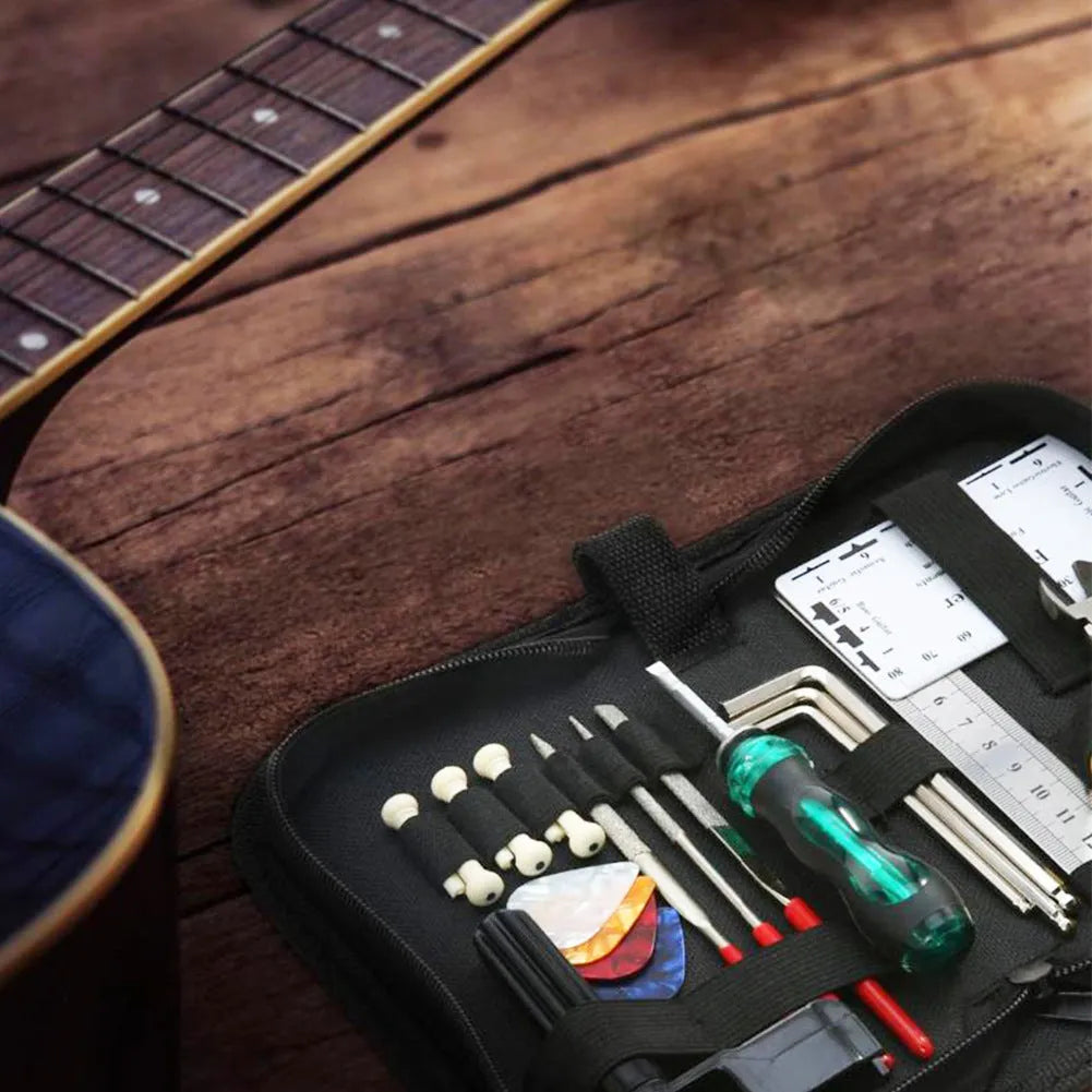 Black plastic and metal guitar repair tool kit for guitar, bass, mandolin, banjo maintenance.
