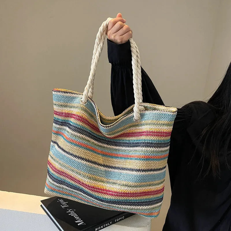 Blue straw woven nylon shoulder bag with large capacity and polyester lining.