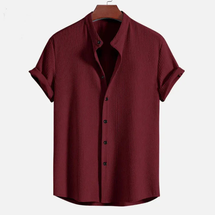 Men's loose fit short sleeve polyester shirt in multiple colours on a size chart background.