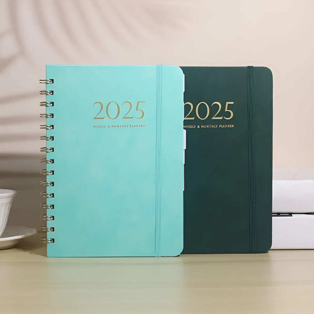 A5 leather notebook with metal coil binding showing multiple colour options including black, blue, brown, and green.
