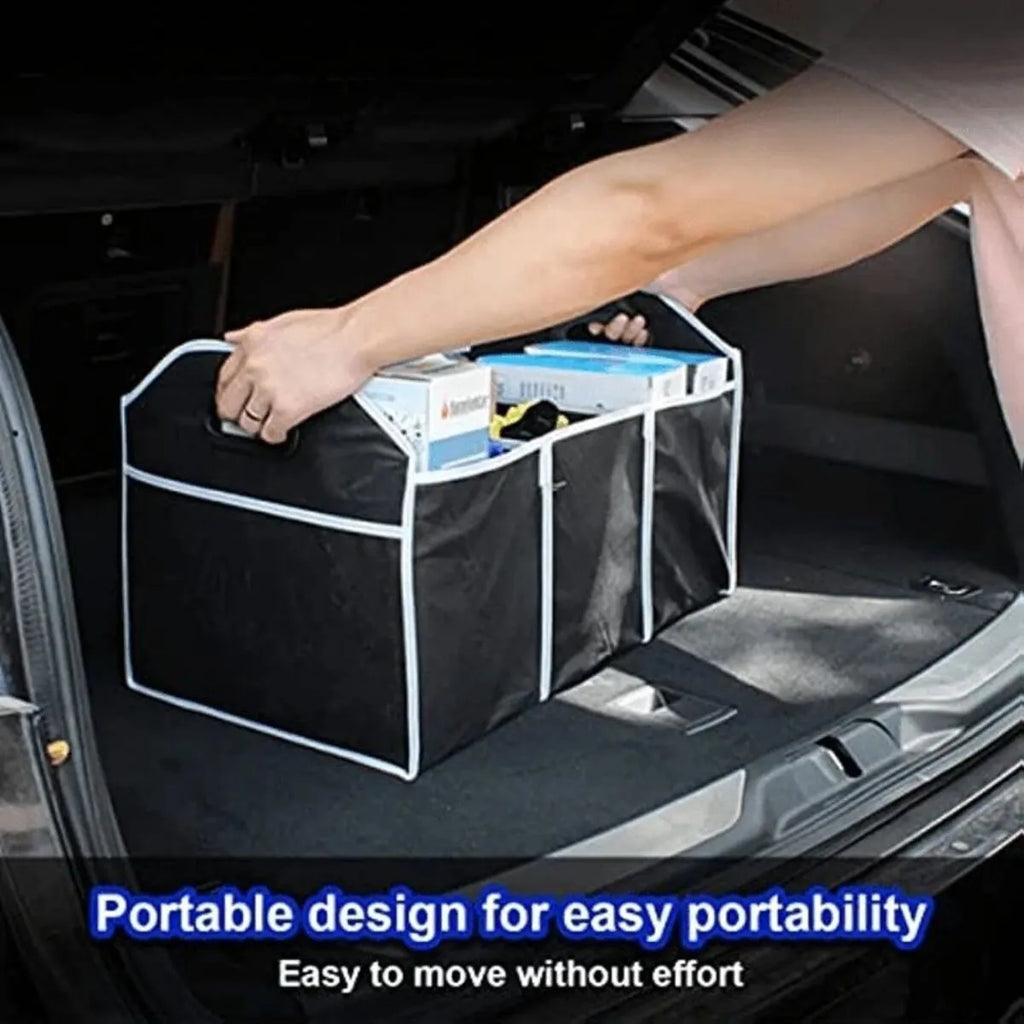 Black car multi-pocket trunk organiser with foldable lid and tie-down straps on car boot floor