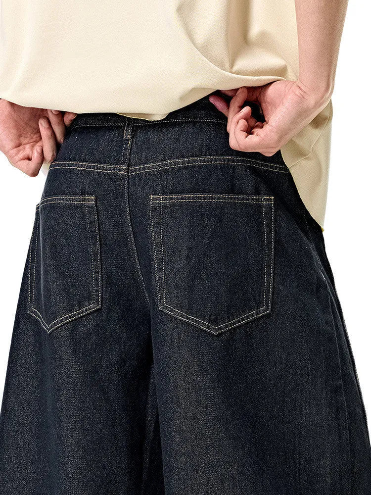 Men's wide leg denim trousers in original cow colour showing relaxed fit and mid waist construction