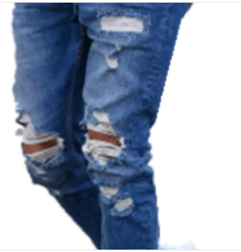 Men's deep blue jeans with hole detail showing cotton fabric texture and contemporary styling