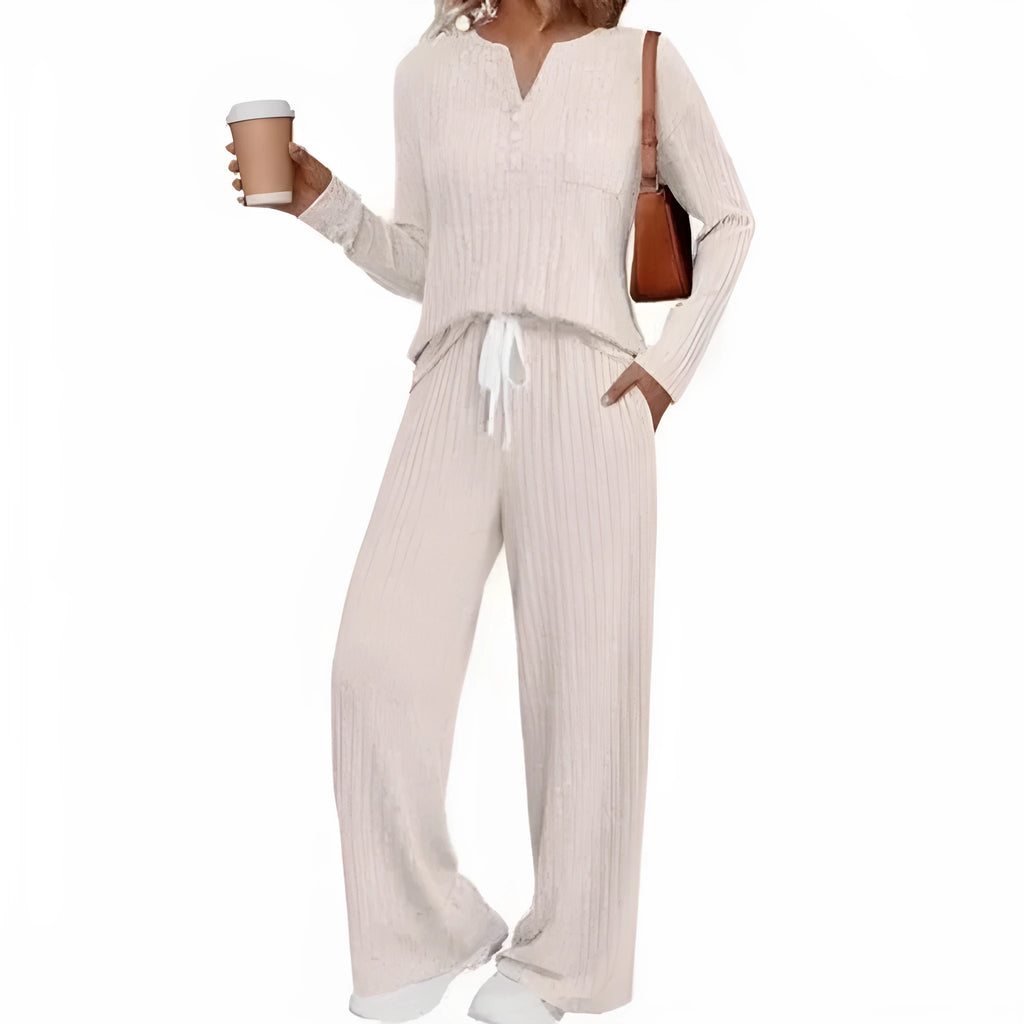 Woman wearing a striped V-neck knit long coat with lace-up detail and pants from a casual streetwear set.