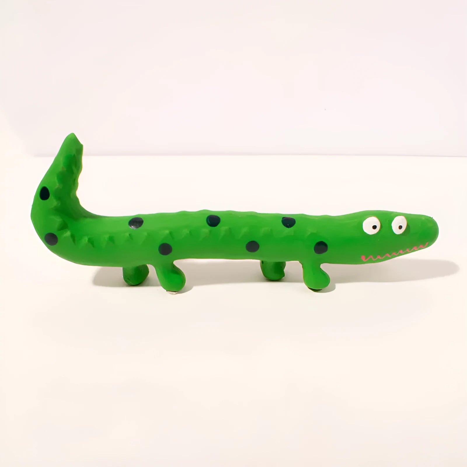 Green lizard-shaped dog chew toy with textured surface and squeaker for aggressive chewing dogs