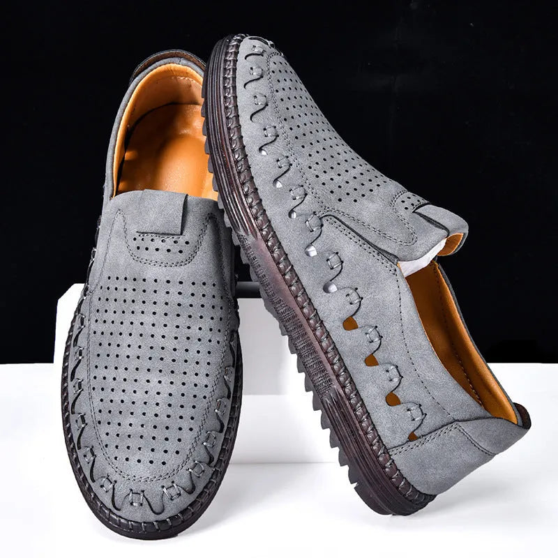 Men's brown casual slip-on shoes with round toe, hollowed detail, and sewn sole on a neutral background.