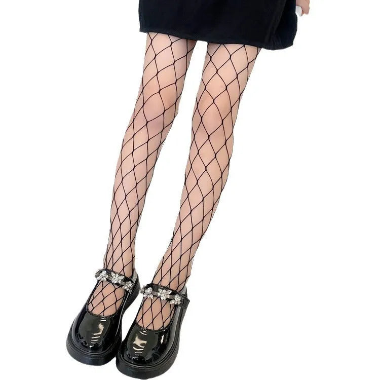 Women's black and white mesh pantyhose showing large, medium, and small fishnet patterns on leg