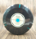 Black and white AC Sweeping Robot automatic vacuum cleaner on a hardwood floor.