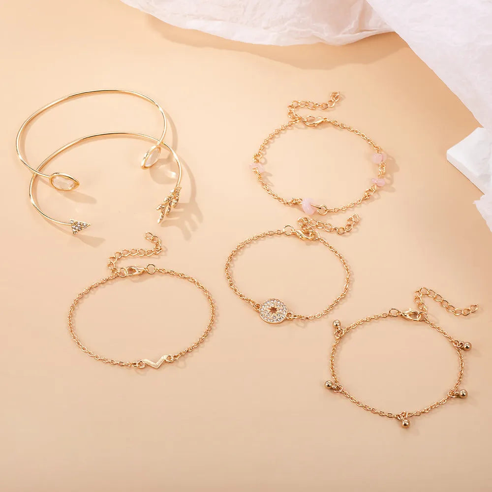 Gold zinc alloy women's bracelet set with arrow, water drop, and V-shaped pendants