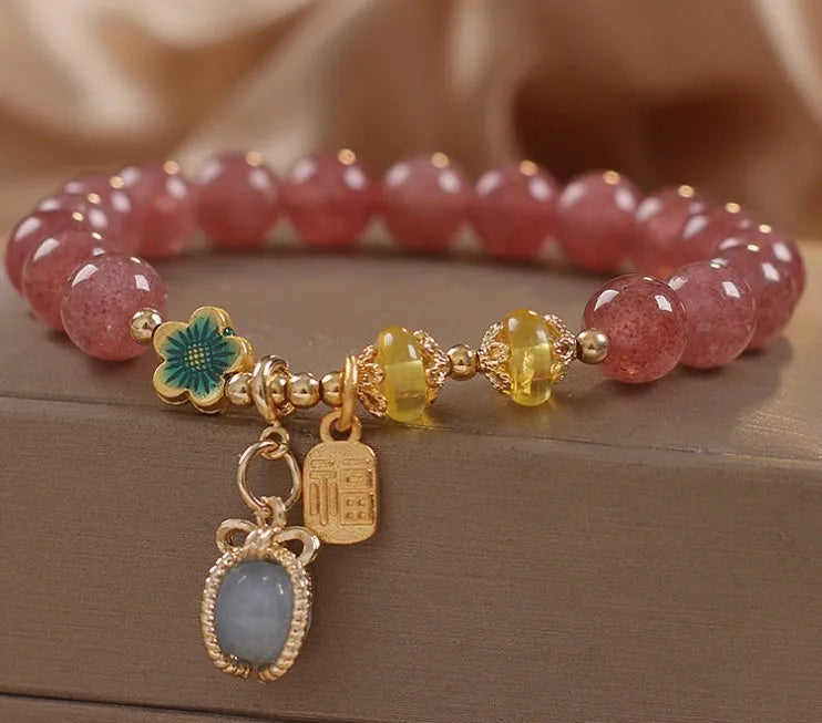 Red strawberry quartz beaded bracelet with alloy metal accents and rhinestone decorative details for women